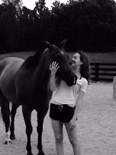 A woman petting a horse